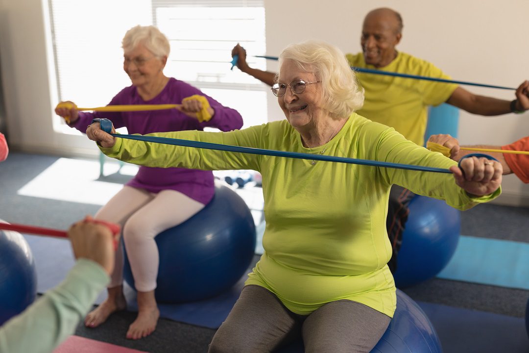 Seniors exercising in gym