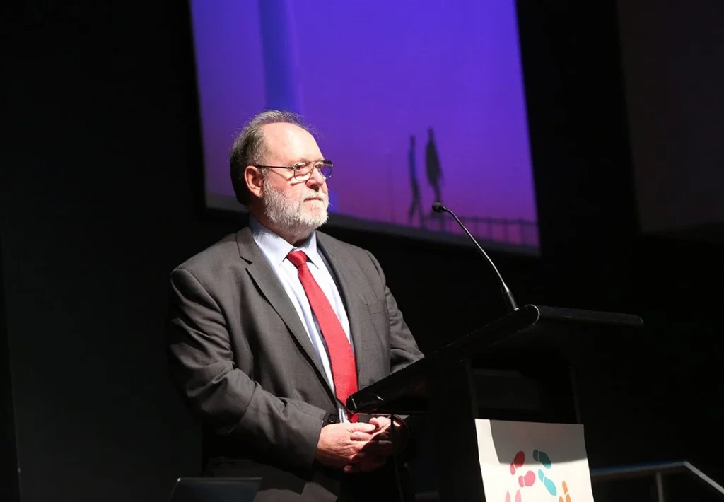 Dennis Frost presenting at a conference in 2017