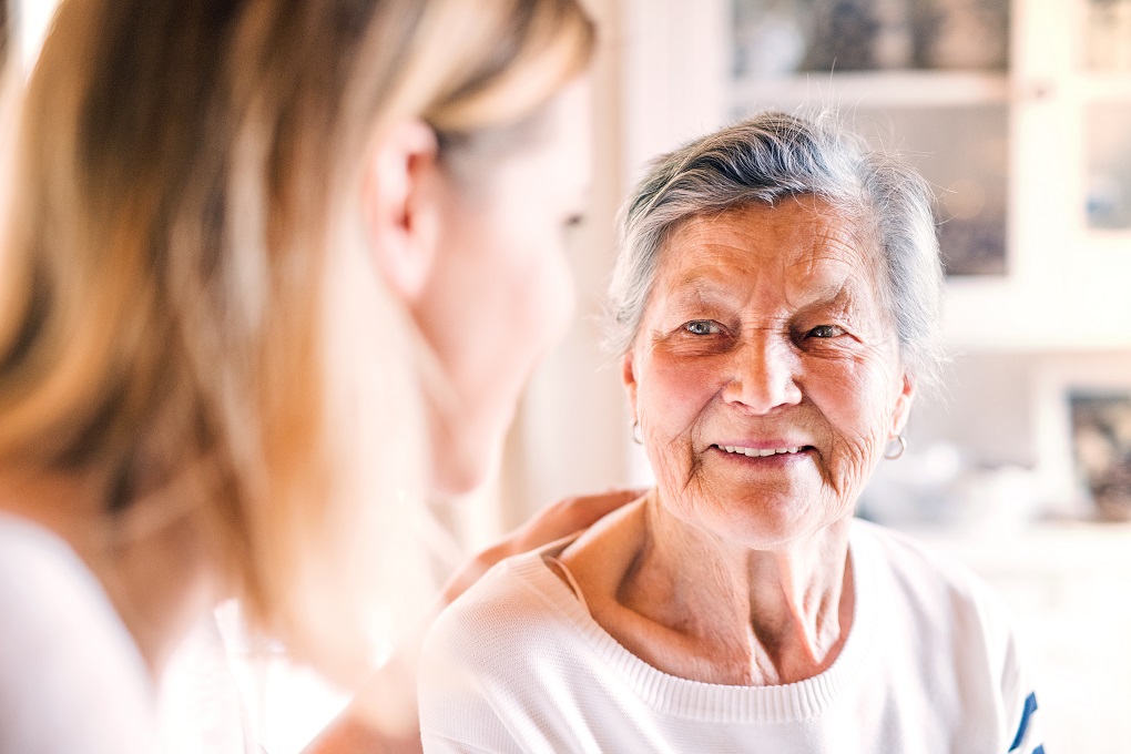 female visitor and elderly woman