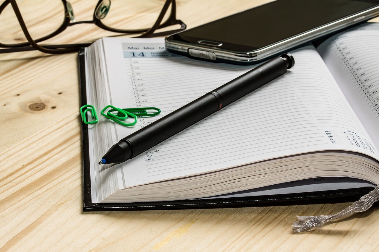 diary, glasses and mobile phone